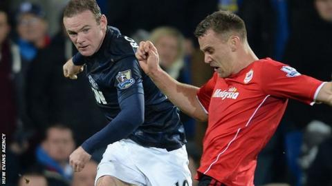 Ben Turner tries to block a Wayne Rooney shot