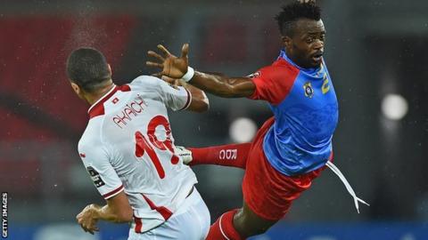 Tunisia forward Ahmed Akaichi (left) jumps to head the ball with DR Congo defender Issama Mpeko
