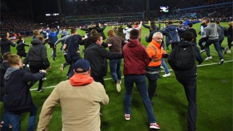 Fans surge past a steward at Villa Park