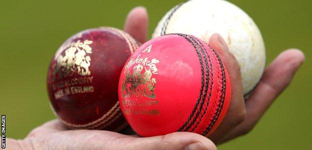 Red, pink and white cricket balls