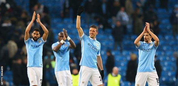 Manchester City players applaud fans