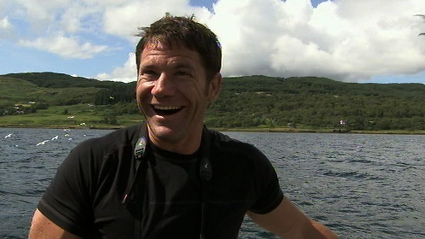 Steve Backshall smiling on a boat