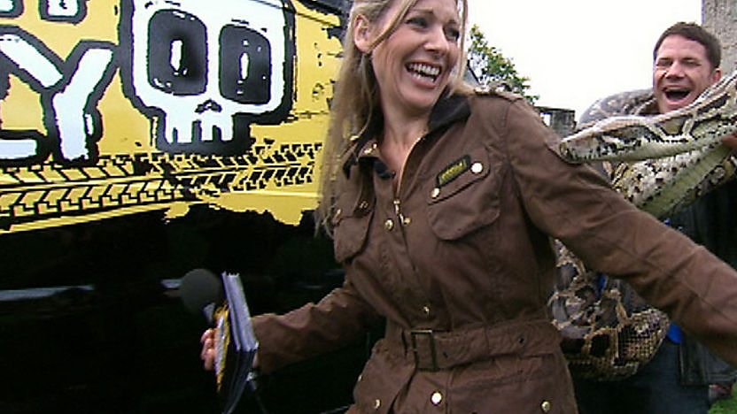 Steve Backshall chases Naomi Wilkinson whilst holding a snake