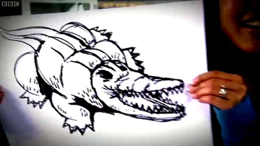 hands drawing a crocodile