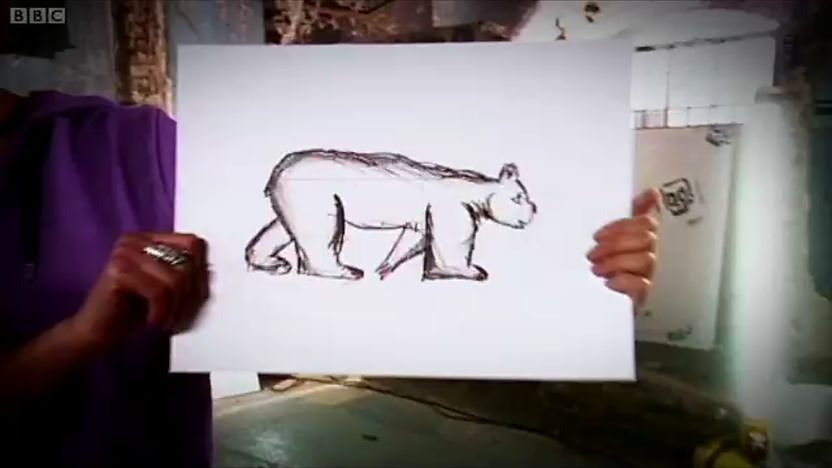 hands holding up picture of bear