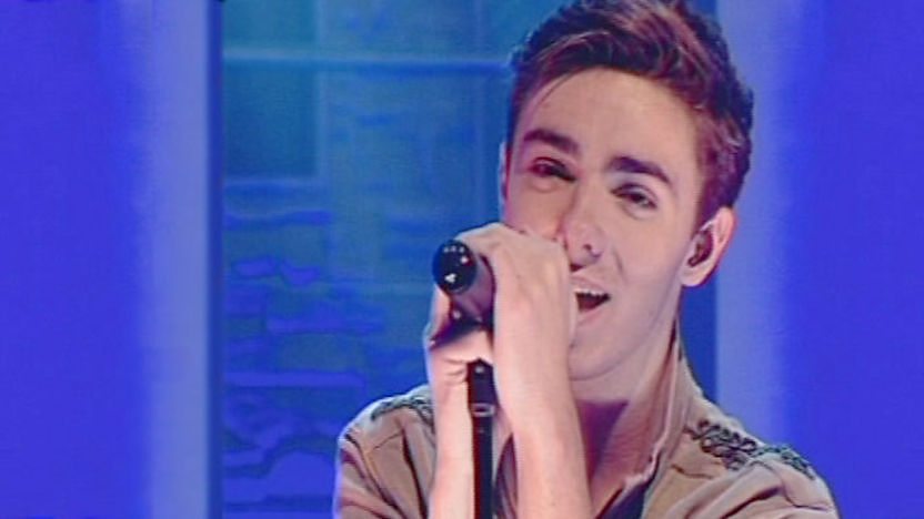Nathan singing, from The Wanted boy band