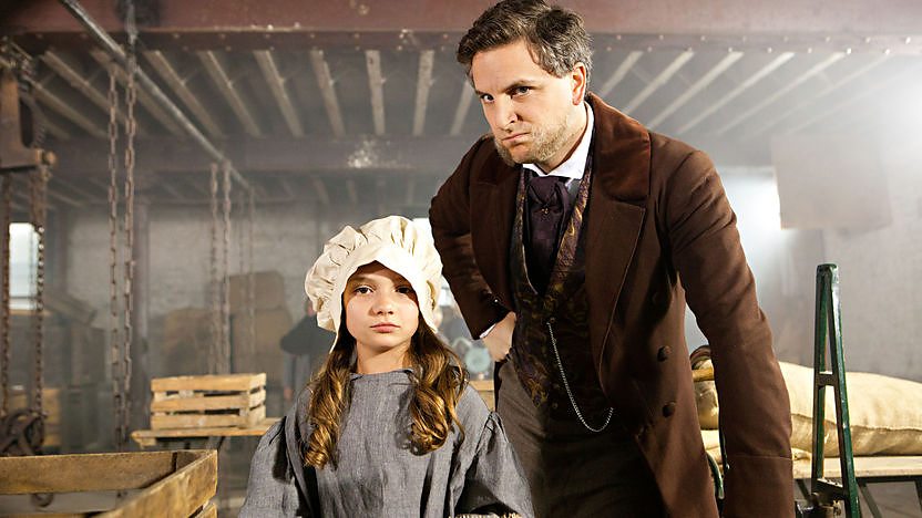 A work house master looms over a small female worker