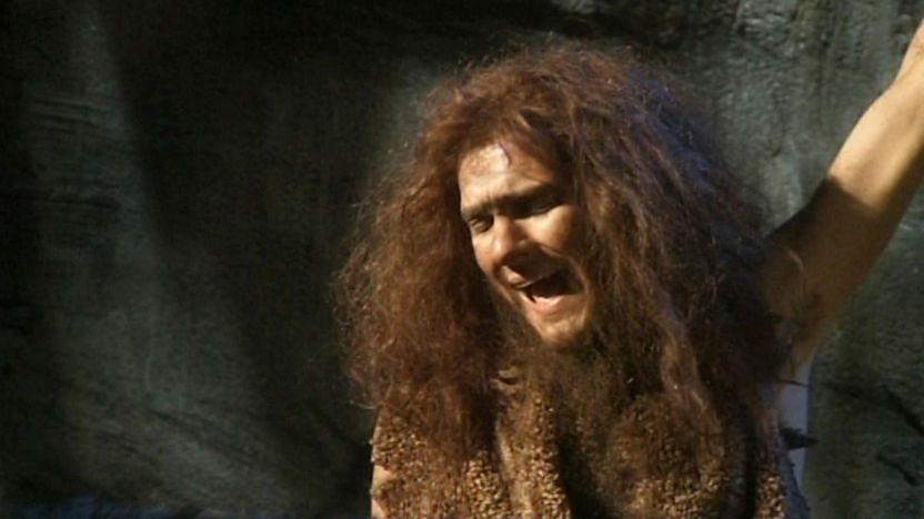 A stone age man sings