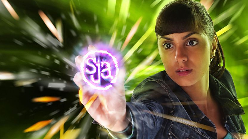 Rani holding glowing SJA logo.