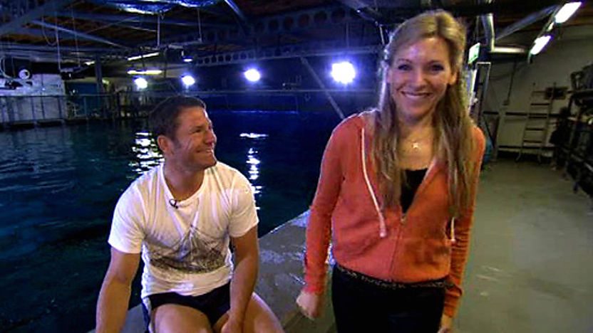 Steve Backshall and Naomi Wilkinson by a shark tank