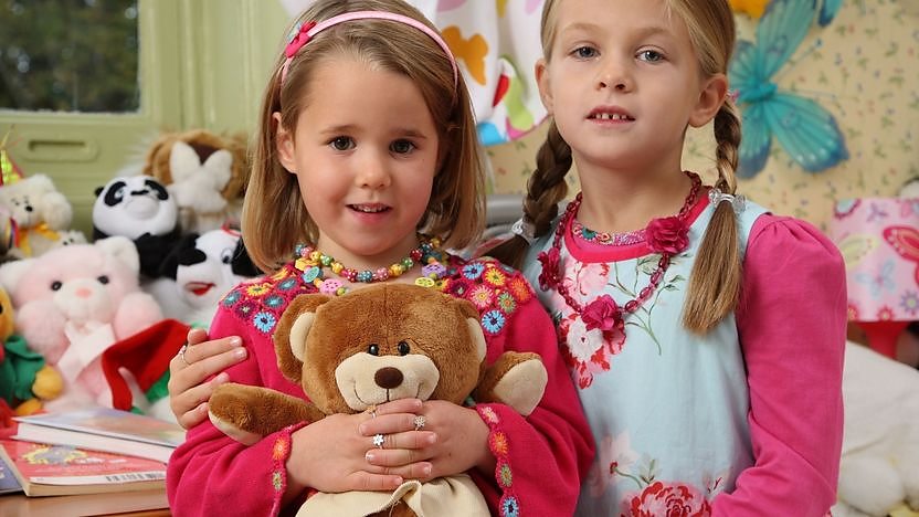 two girls stood in bedroom