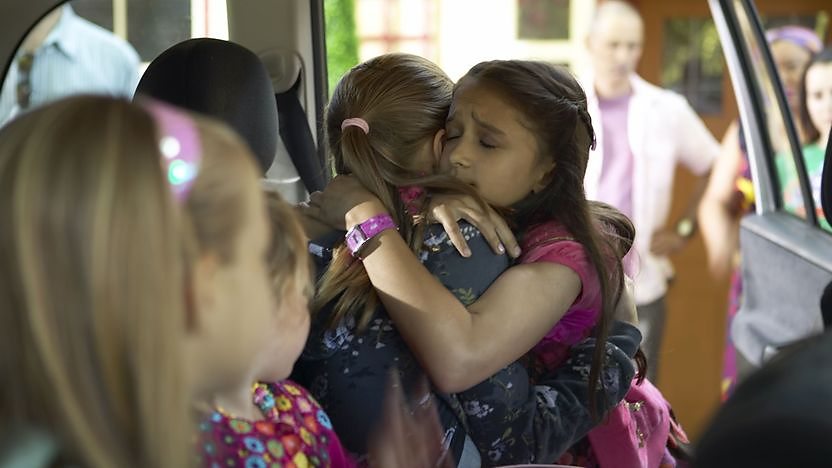 hugging goodbye in a car