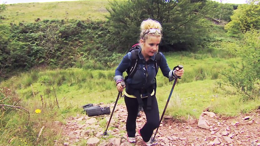Helen Skelton pulling tyres up a hill