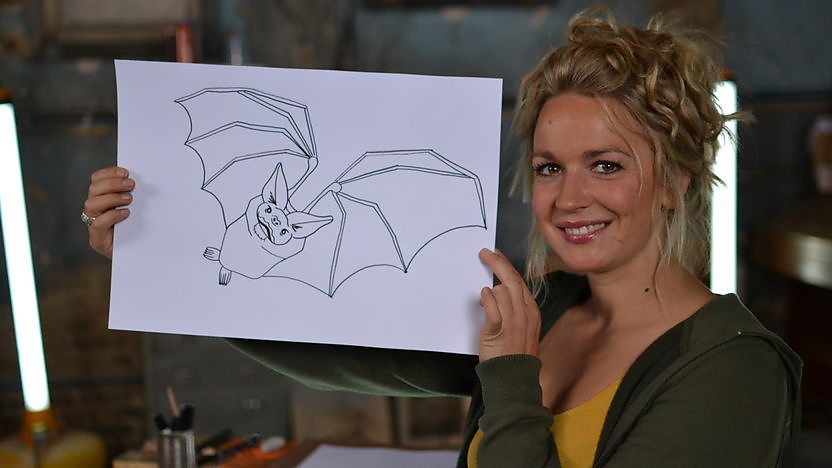 Nicola holding a drawing of a bat.