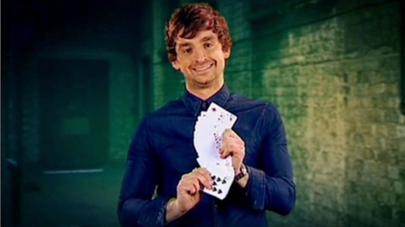 Fergus holding a pack of cards.