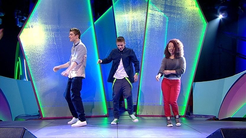Richard, Adian and Saffron Coomber dancing on stage.