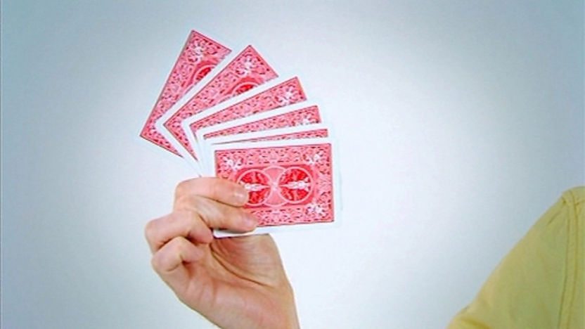 James' hand holding a fan of cards.