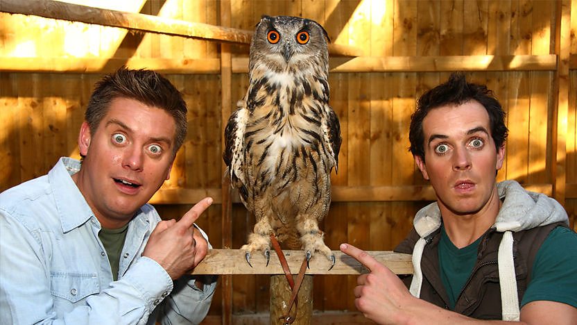 Dick and Dom kissing a dog.