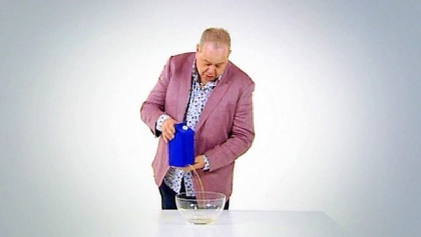John holding a carton of water.