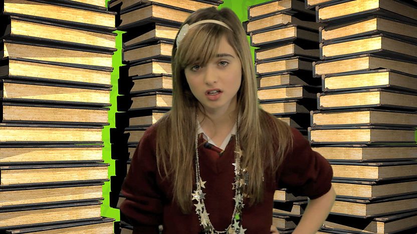 Zoe-Marie in front of books.