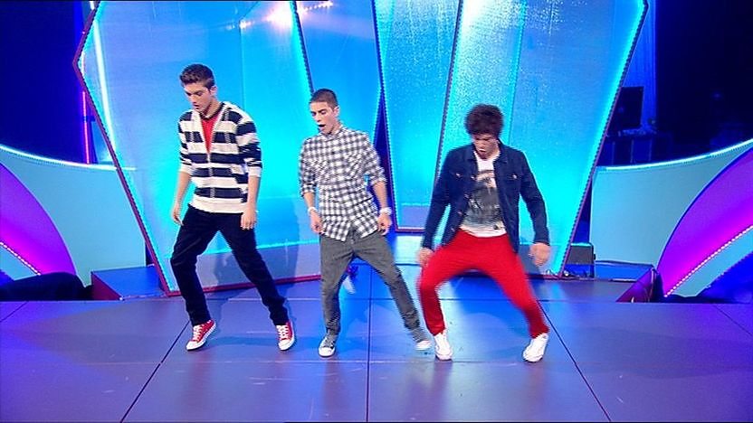 Aidan Davis, Richard Wisker and Tyger Drew-Honey dancing on stage.
