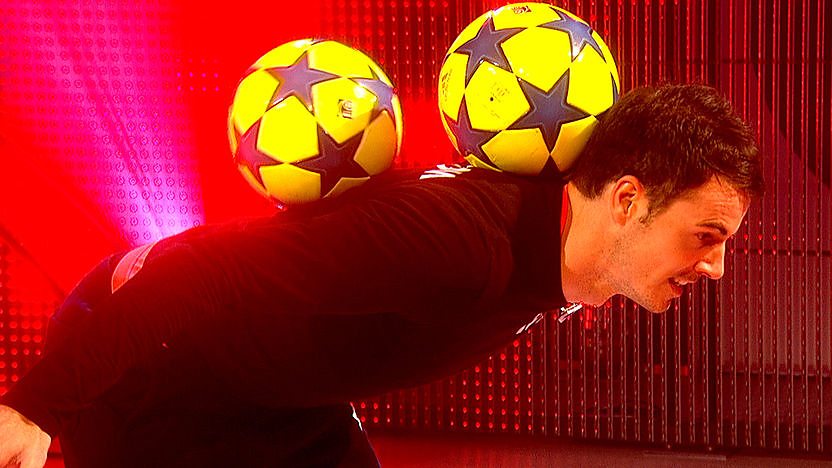 Billy Wingrove from freestyle team F2 balancing two balls on the back of his neck.