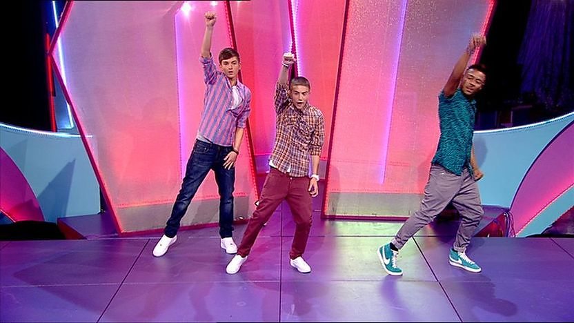 Aidan Davis, Richard Wisker and Marcus Collins dancing on stage.