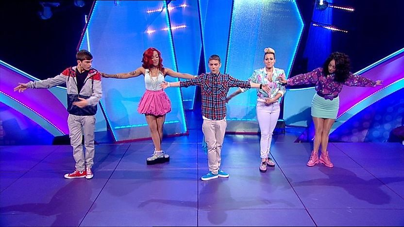 Aidan Davis, Richard Wisker and Stooshe dancing on stage. 