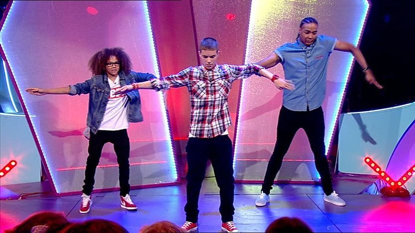 Aidan Davis with Jordan and Perri dancing on stage.