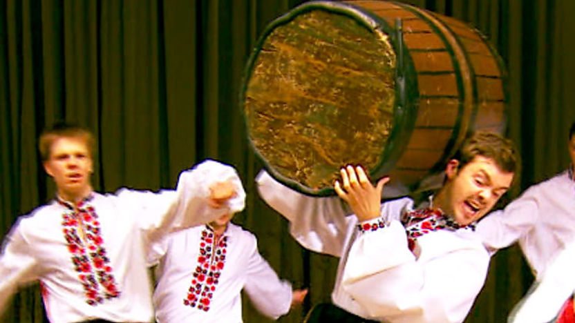 Barney Harwood holding a barrel as he cossack dances on Blue Peter