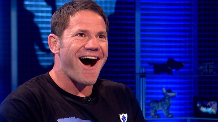 Steve Backshall laughing as he receives his gold Blue Peter badge