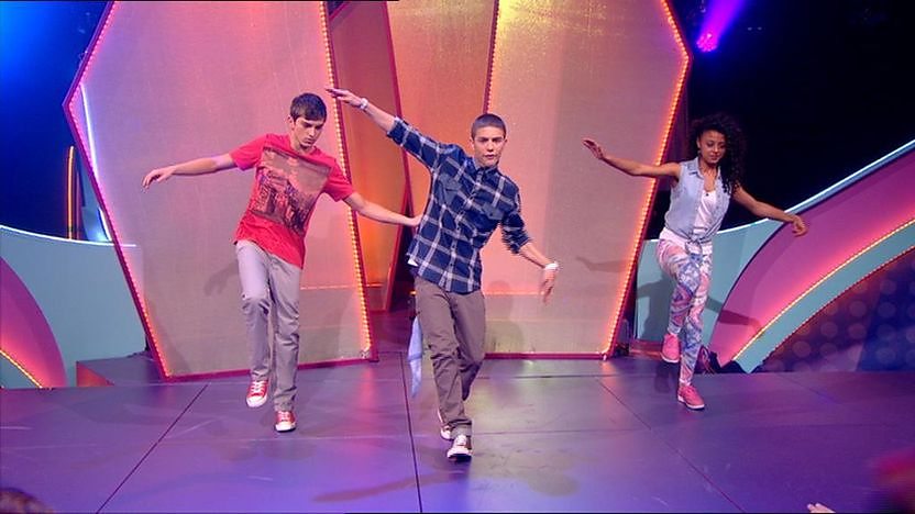 Aidan Davis dancing on stage with Richard Wisker and Talia