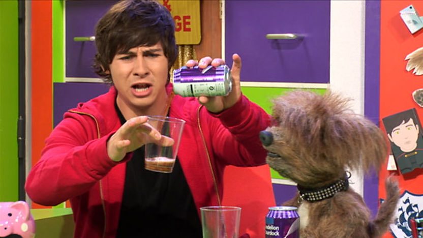 Ben pouring a fizzy drink into a glass.