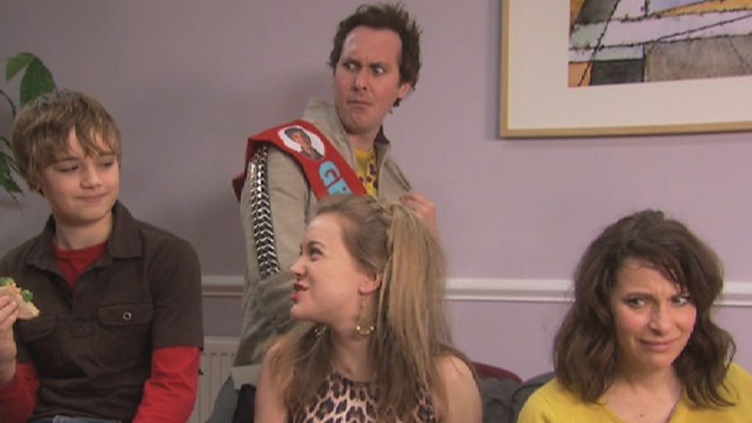 Stanley Brown sitting on a couch with his family.