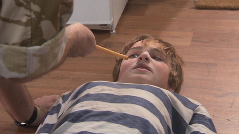 stanley brown lying on the floor after being tackled by Harry as part of his training.