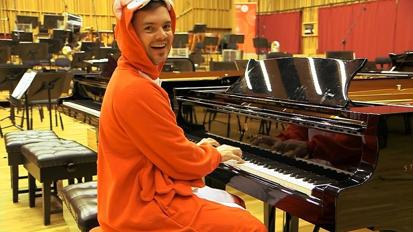 Barney Harwood playing a piano.