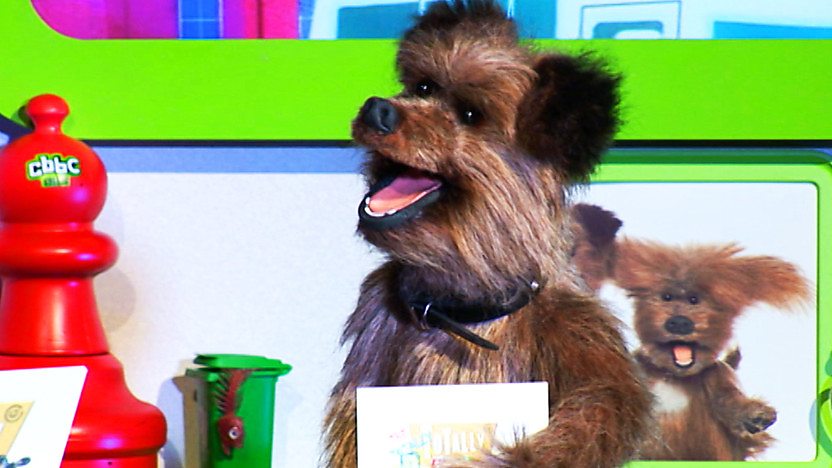 Hacker T Dog holding a Totally Rubbish quiz cue card.