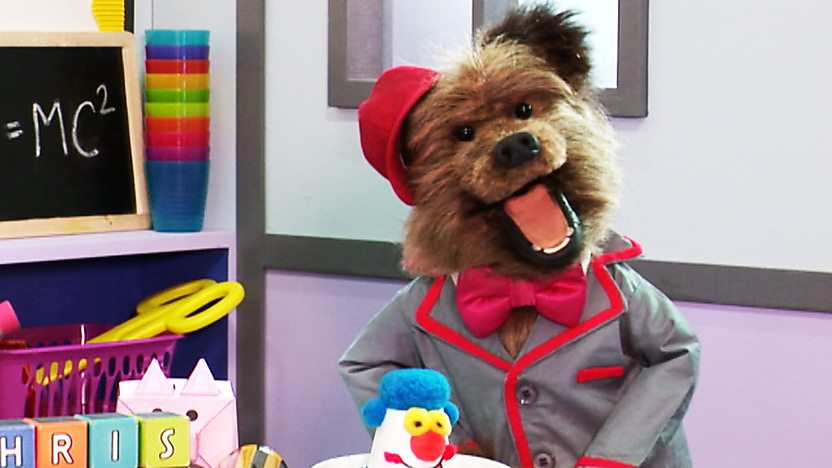 Hacker T. Dog wearing a school uniform in a classroom.