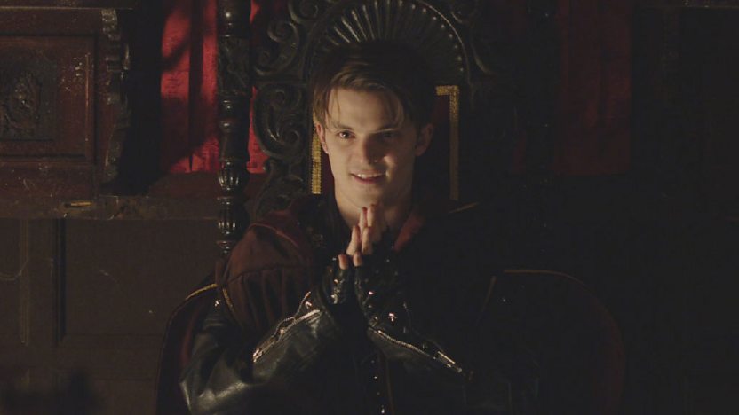 Malik sitting on Dracula's throne.