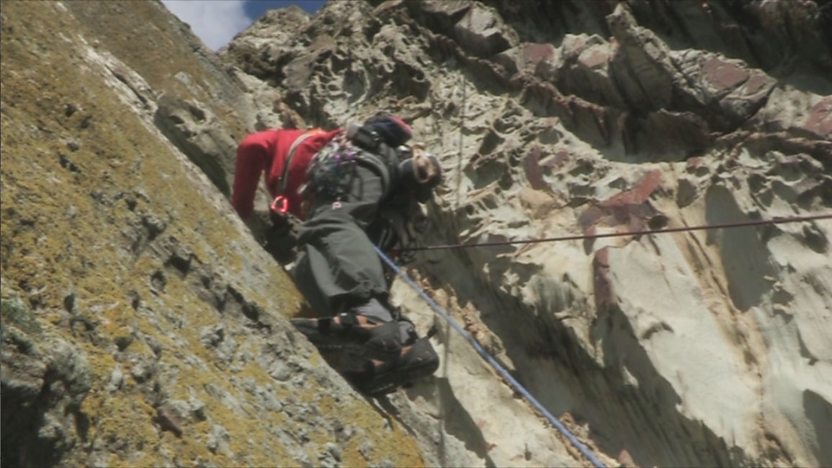 Leo climbing a rock face in North Wales.