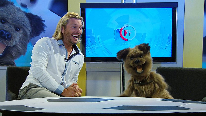 Hacker T Dog and Robbie Savage in the Football Focus studio laughing.