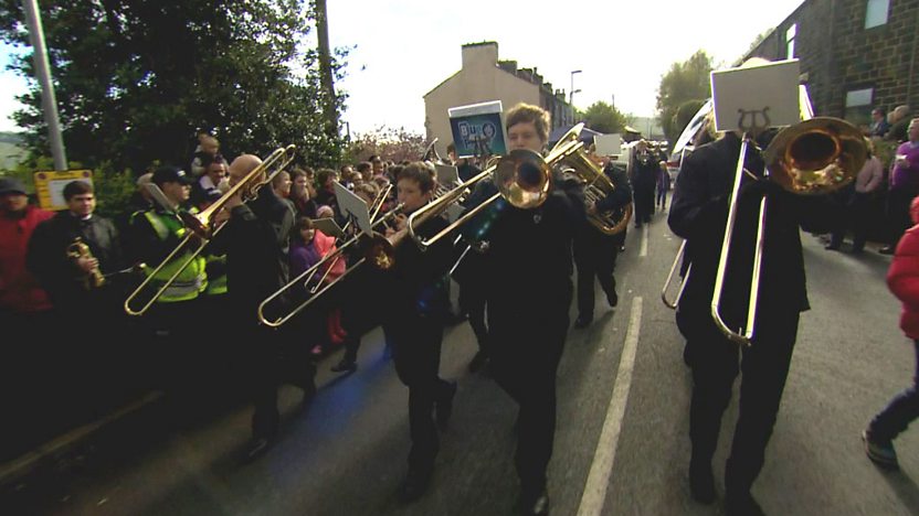 Barney playing the trombone with a brass band