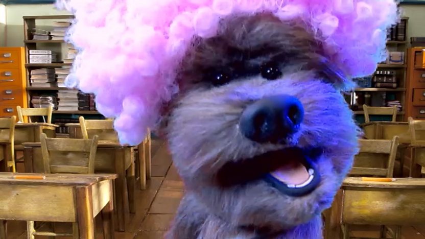 Dodge wearing a pink wig.