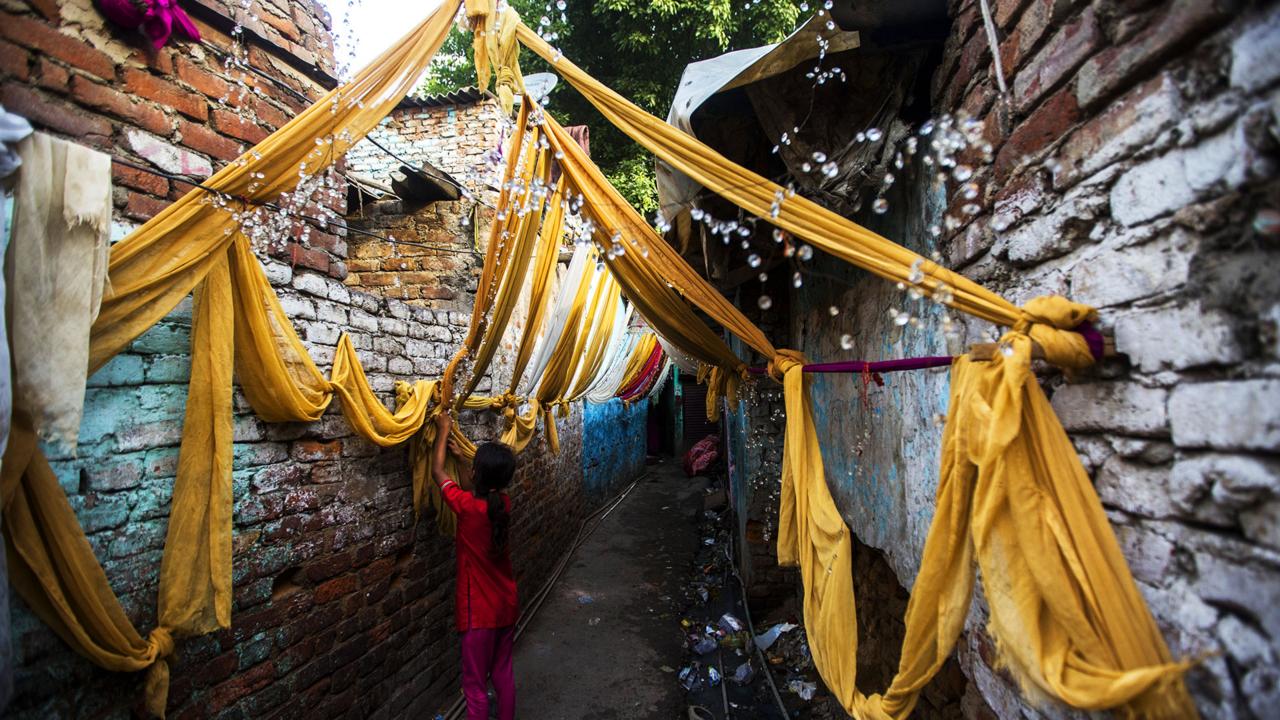 A young girl decorates a Kathputli alleyway (Credit: Credit: AFP/Getty) A young girl decorates a Kathputli alleyway (Credit: Credit: AFP/Getty)
