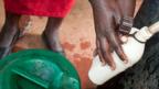 Woman collects water at a Lifelink station (Copyright: Jonathan Kalan)