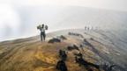 Sulphur miners walk across the lip of Indonesia's Ijen crater. (Mark Johanson)