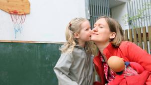 A three-year-old German girl kisses her mother goodbye. (Adam Berry/Getty Images)