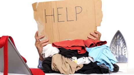 Do job responsibilities go as far as doing the laundry for your boss? (Lisa Blue/Getty)