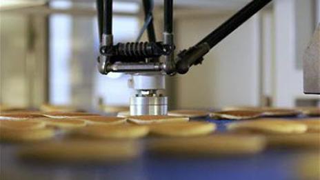 The robot picks up the pancake with suction (ABB)