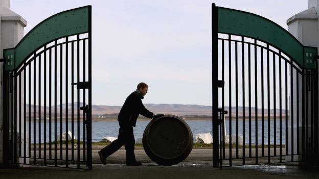 Pushing a barrel of Bruichladdich whisky (Credit: Credit: Jeff J Mitchell/Getty Images) Pushing a barrel of Bruichladdich whisky (Credit: Credit: Jeff J Mitchell/Getty Images)